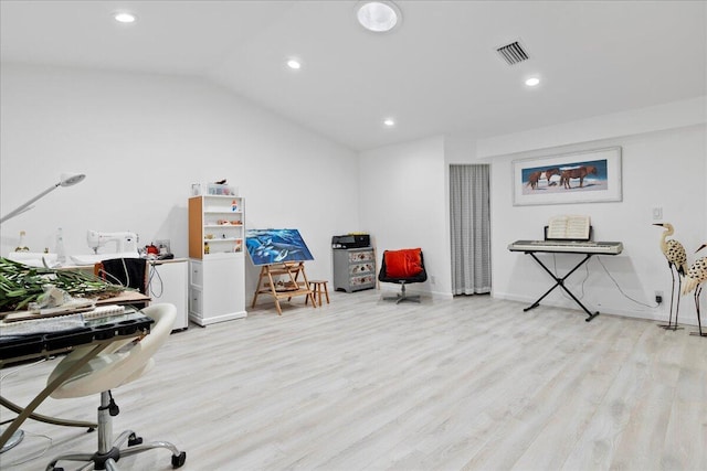 home office with light hardwood / wood-style floors and lofted ceiling