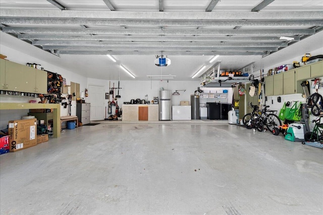 garage with water heater and a garage door opener