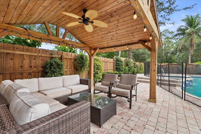 view of patio with an outdoor living space and ceiling fan