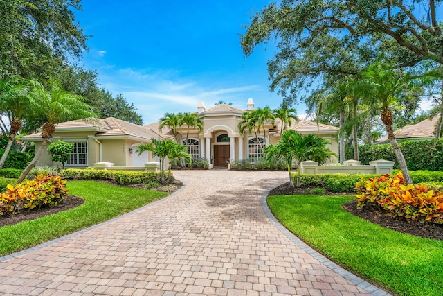 mediterranean / spanish-style house with a front lawn