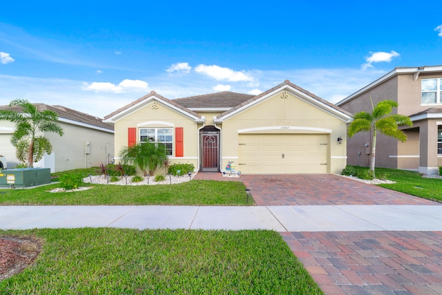 view of front of property with a front yard and a garage