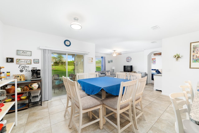 tiled dining area with ceiling fan