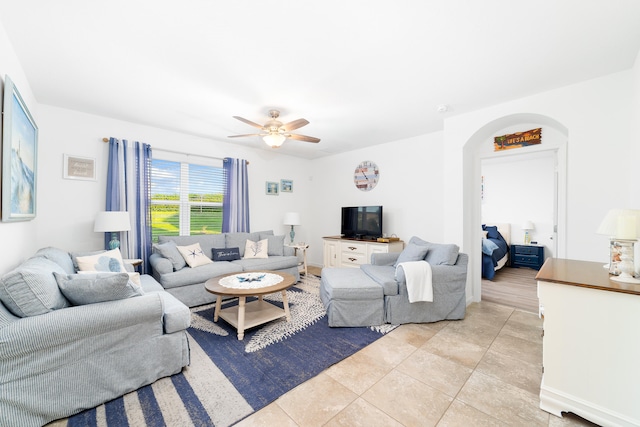 tiled living room featuring ceiling fan