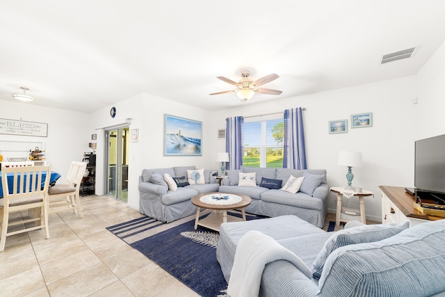 living room with ceiling fan and light tile patterned floors