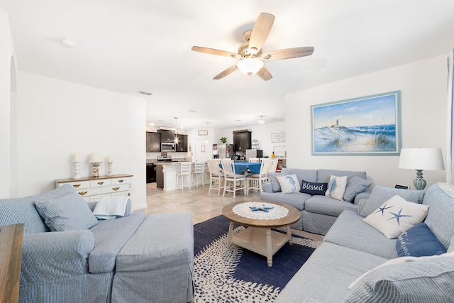 tiled living room with ceiling fan