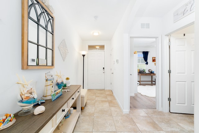 foyer entrance with light tile patterned floors