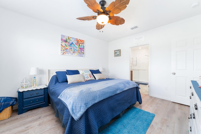 bedroom with ensuite bath, ceiling fan, and light wood-type flooring