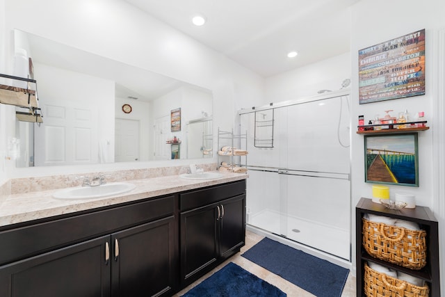 bathroom featuring vanity and a shower with shower door