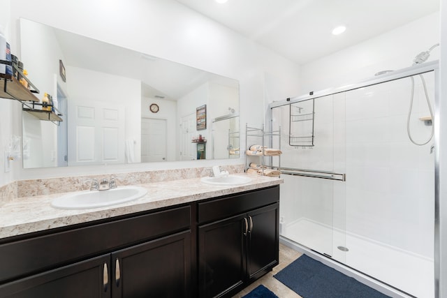 bathroom featuring vanity and a shower with door