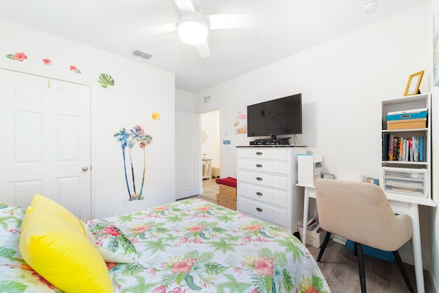 bedroom with ceiling fan, wood-type flooring, and a closet