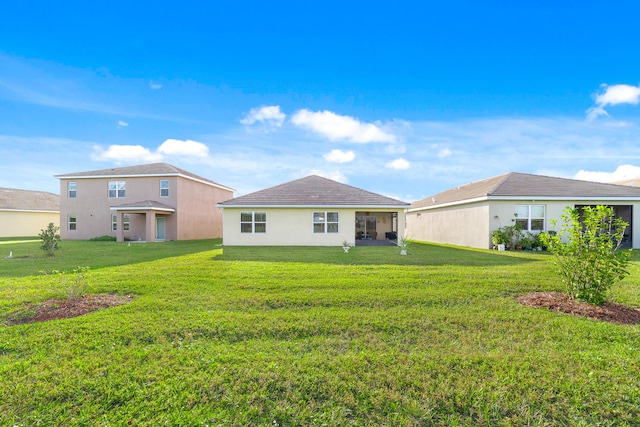 rear view of house with a yard