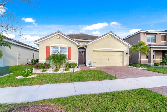 view of front of house featuring a garage and a front lawn