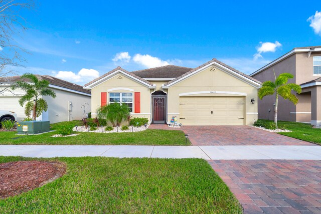 ranch-style home featuring a front yard and a garage