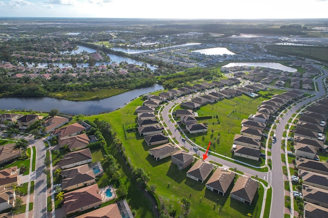 birds eye view of property with a water view