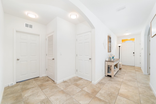 hallway featuring light tile patterned floors