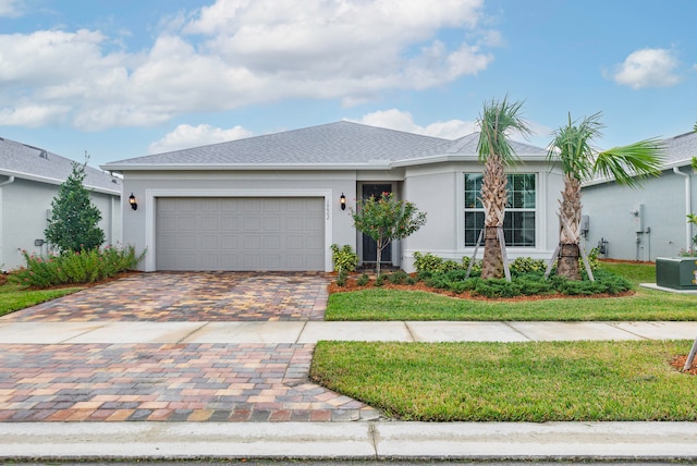 ranch-style house featuring a garage and a front yard