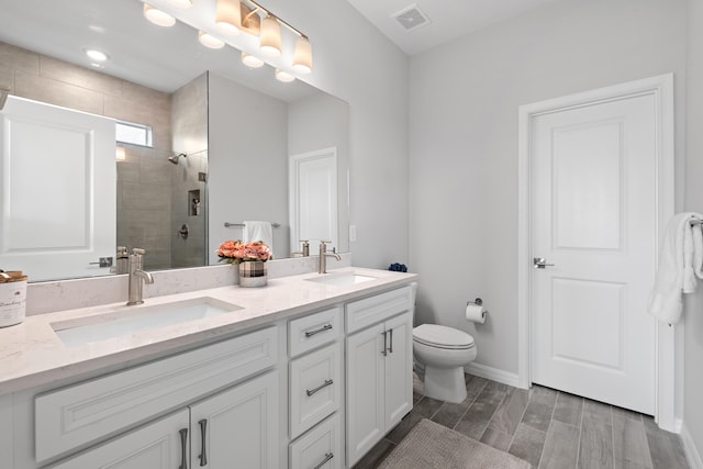 bathroom featuring hardwood / wood-style flooring, vanity, toilet, and an enclosed shower