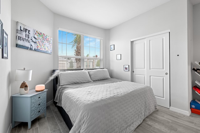 bedroom featuring a closet and light hardwood / wood-style flooring