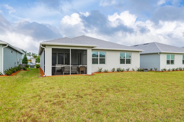 back of property featuring cooling unit, a lawn, and a sunroom