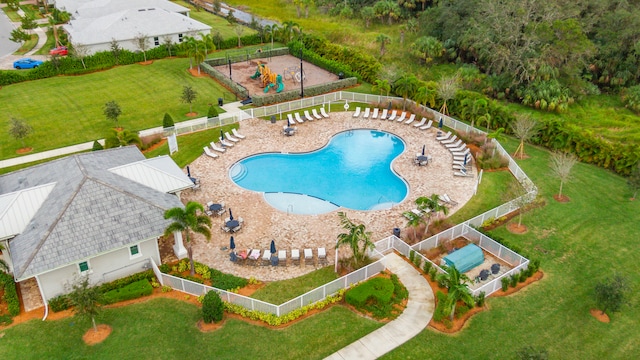 view of pool with a patio area and a lawn