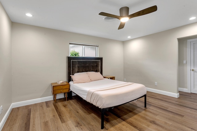 bedroom with light hardwood / wood-style flooring and ceiling fan