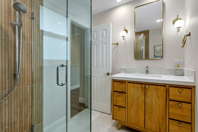 bathroom with walk in shower, vanity, and wood-type flooring