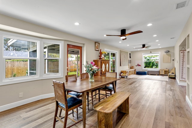 dining area with light wood-type flooring and ceiling fan