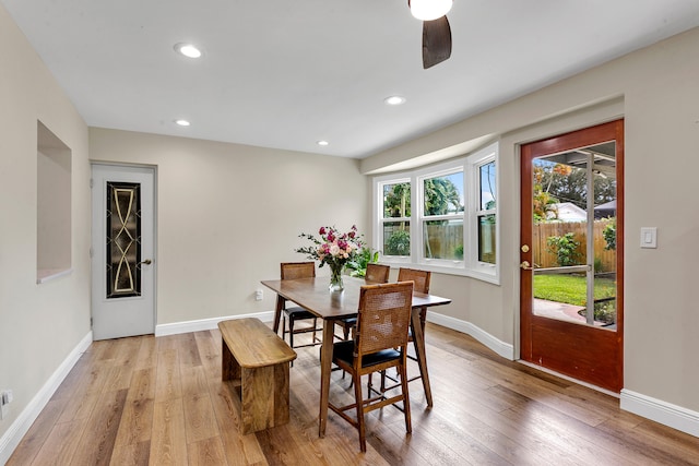 dining space with light hardwood / wood-style floors and ceiling fan