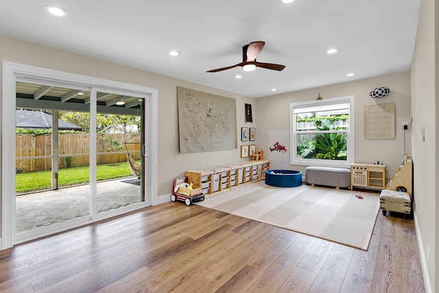 playroom with light wood-type flooring and ceiling fan