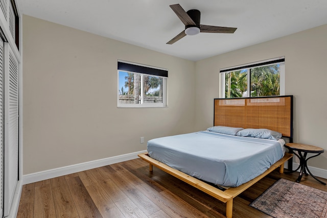 bedroom with hardwood / wood-style flooring, ceiling fan, and a closet