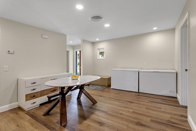 dining area with light hardwood / wood-style floors