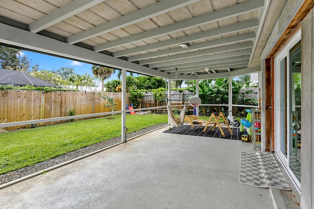 unfurnished sunroom featuring beamed ceiling