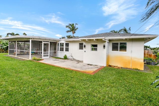 rear view of property with a patio, a sunroom, and a yard