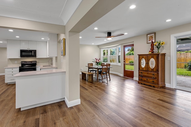 kitchen featuring black appliances, white cabinetry, sink, ceiling fan, and light hardwood / wood-style flooring