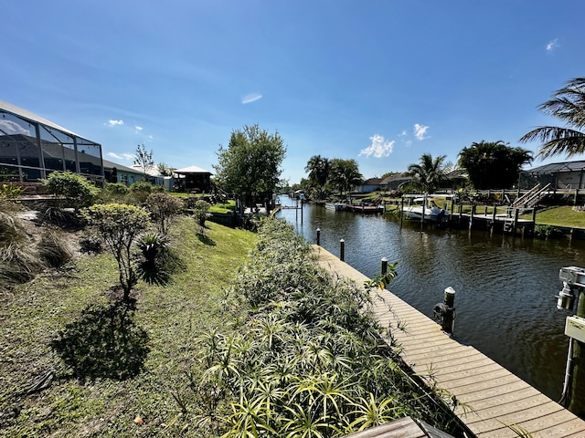 dock area featuring a lanai and a water view