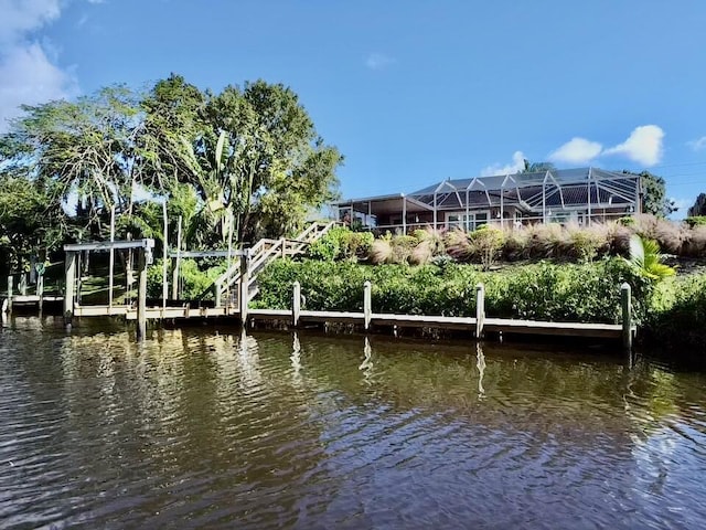 dock area featuring glass enclosure and a water view