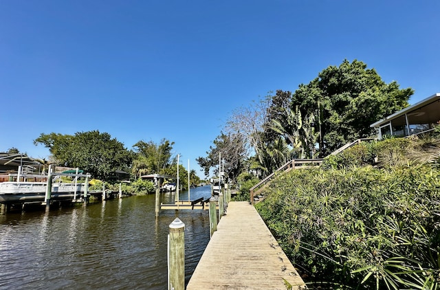 view of dock with a water view and boat lift