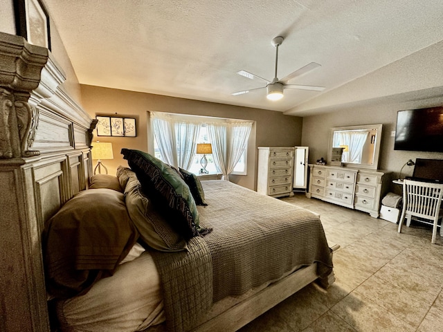 bedroom with a ceiling fan, lofted ceiling, and a textured ceiling