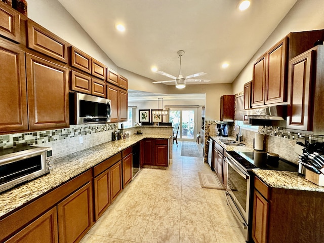 kitchen with backsplash, appliances with stainless steel finishes, a sink, a peninsula, and under cabinet range hood