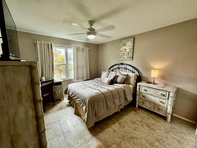 bedroom with baseboards, a ceiling fan, and light tile patterned flooring