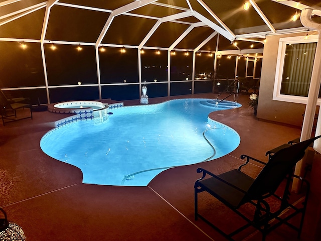 pool featuring a lanai, a patio area, and an in ground hot tub