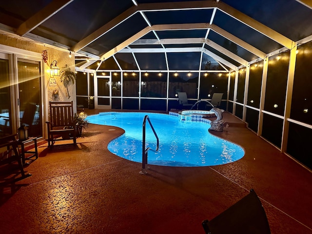 view of pool with a patio area, a lanai, and a pool with connected hot tub