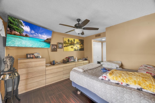 bedroom featuring ceiling fan, dark hardwood / wood-style floors, a textured ceiling, and a closet