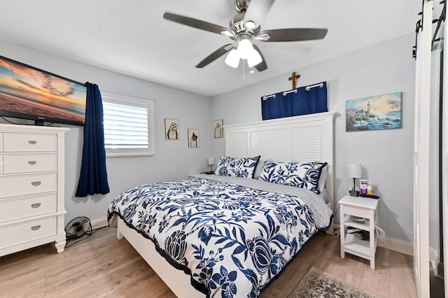 bedroom with ceiling fan and wood-type flooring