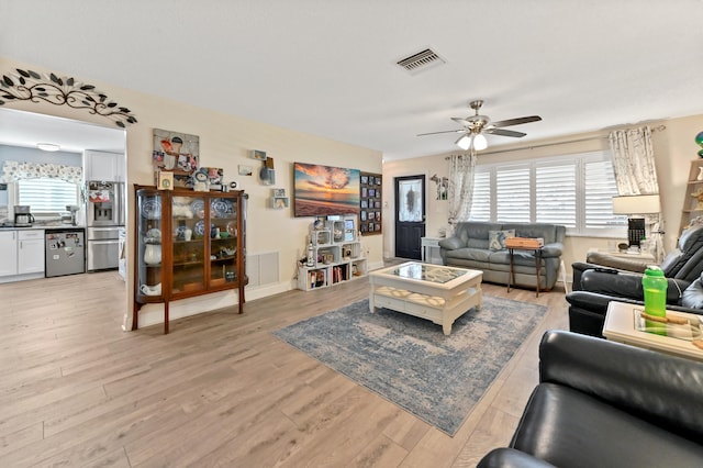 living room featuring light wood-type flooring and ceiling fan