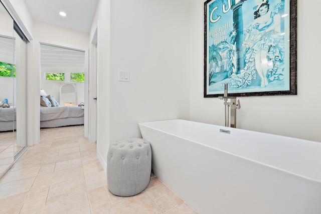 bathroom featuring tile patterned floors and a tub