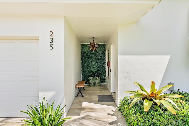 view of exterior entry with a garage