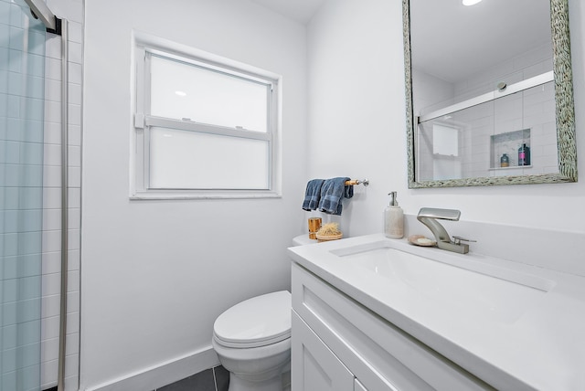 bathroom featuring tile patterned floors, vanity, toilet, and an enclosed shower