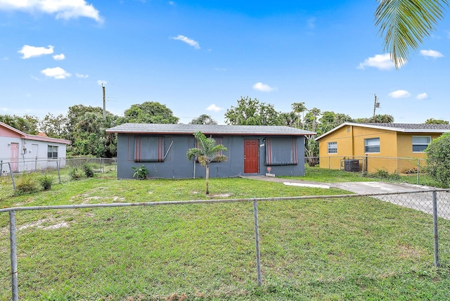 ranch-style house featuring central air condition unit and a front yard