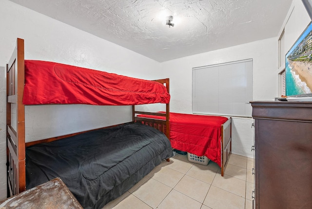 tiled bedroom featuring a textured ceiling